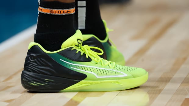 View of green and black Puma shoes.